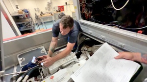 U.S. Coast Guard engineers troubleshoot small boat electronics