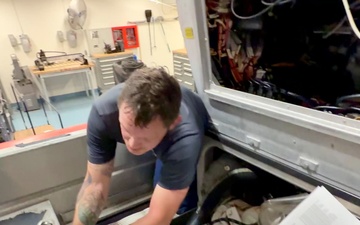 U.S. Coast Guard engineers troubleshoot small boat electronics