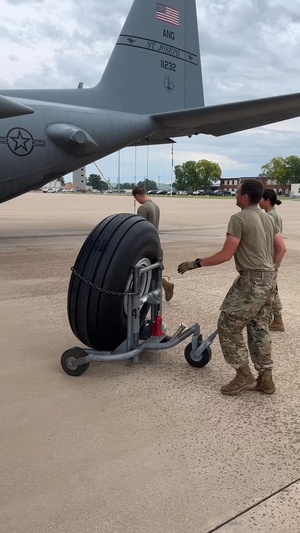 Crew chiefs change aircraft tire