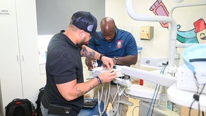 U.S. Navy biomedical technicians collaborate with Panamanian  hospital staff to restore dental equipment