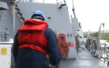 Sailors aboard the USS John Finn conduct a sea and anchor detail in Apra Harbor, Guam