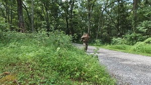 Competitors ruck and run in a Bosnia and Herzegovina soldier task lane - 2025 National Best Warrior