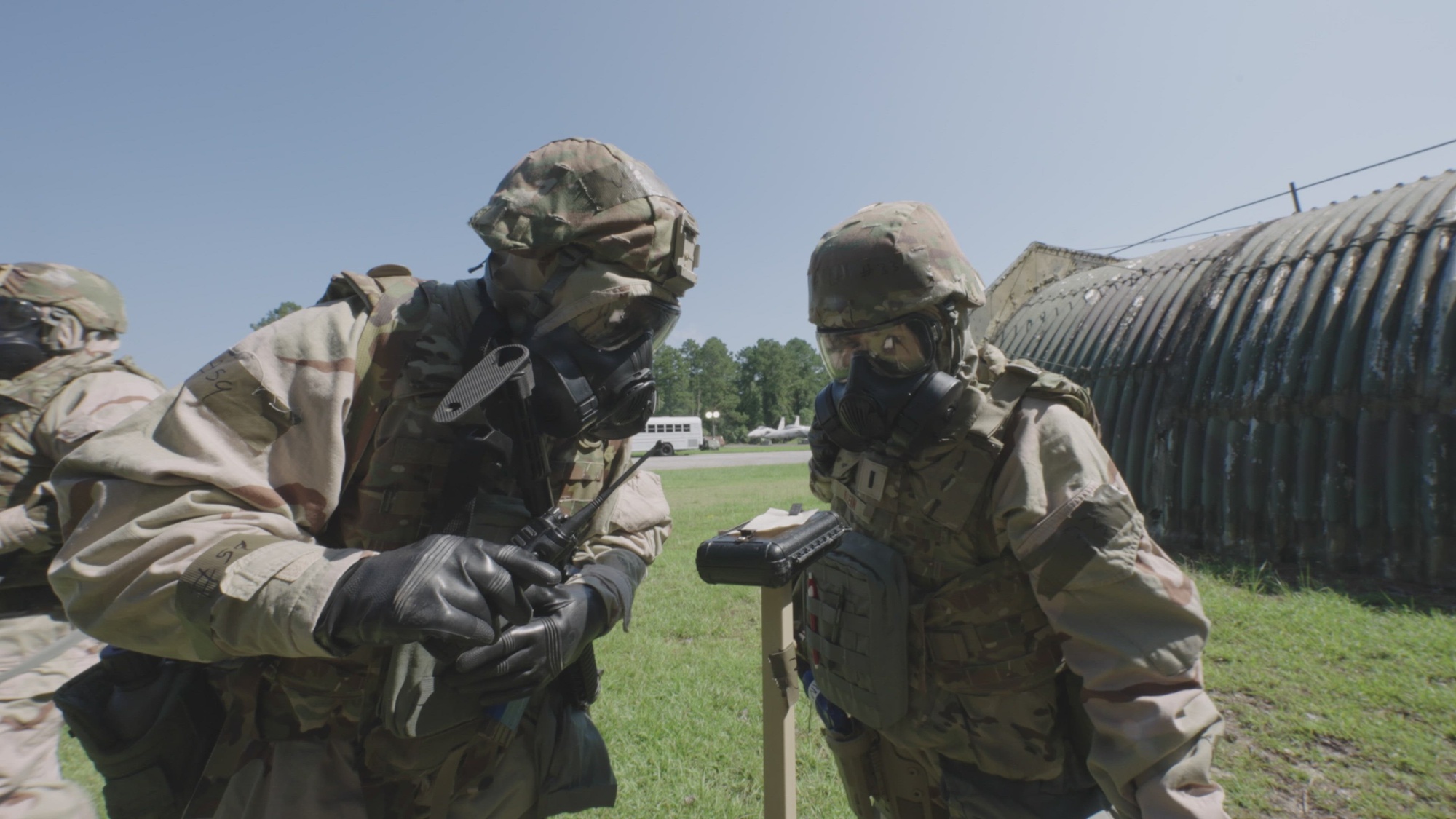 Video thumbnail shows military personnel in protective gear looking at equipment