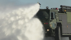 U.S. Marine firefighters with 1st Marine Aircraft Wing perform “pump and roll” procedure