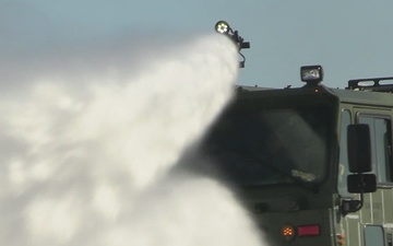 U.S. Marine firefighters with 1st Marine Aircraft Wing perform “pump and roll” procedure