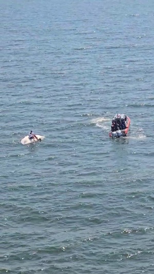 Coast Guard Air Station Houston Air Crew Observes Their Rescue Swimmer Assist 3 Boaters from Capsized Vessel