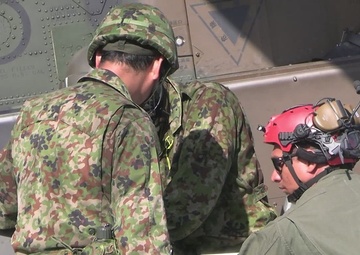 U.S. Marines, Japan Ground Self-Defense Force members load ordnance onto aircraft