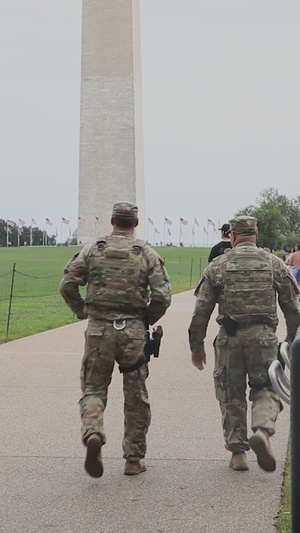 U.S. Air Force Tech. Sgt. Richard Kramer and Airman Devontae Taylor assist a lost child near the Washington Monument in Washington, D.C.