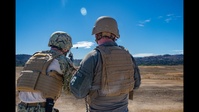 Parallax motion photo of Seabees conducting crew-served weapons training with M203 grenade launcher