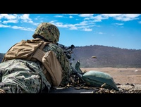 Parallax motion photo of Seabees conducting crew-served weapons training with M240B machine gun