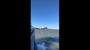 Coast Guard Small Boat Crew Watches Helicopter Fly Over