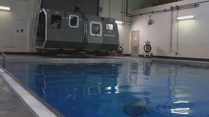 U.S. Marines with MWCS-28 dive into Underwater Egress Training