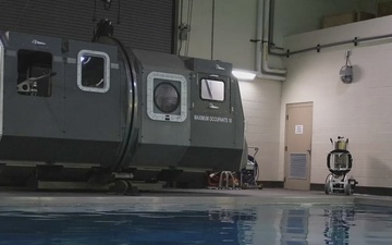 U.S. Marines with MWCS-28 dive into Underwater Egress Training
