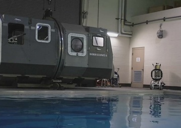 U.S. Marines with MWCS-28 dive into Underwater Egress Training