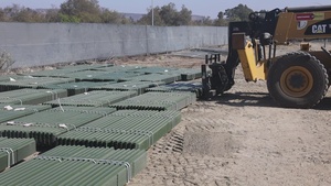 Unloading fence posts for concertina wire (B-Roll)