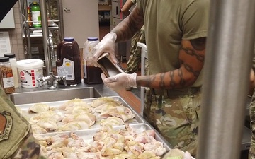 169th Force Support Squadron Airmen prepare and serve lunch at the DFAC
