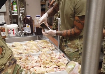 169th Force Support Squadron Airmen prepare and serve lunch at the DFAC