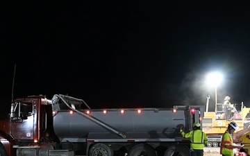 Contractors pour concrete on the runway at Ellsworth Air Force Base