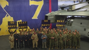 SECNAV cheers for the USNA Midshipmen while aboard USS Iwo Jima