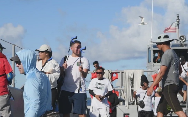 Volunteers participate in a beach cleanup on Diego Garcia