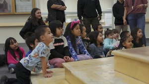 U.S. Marines with 4th Law Enforcement Battalion distribute toys to children attending June Nelson Elementary School during a Toys for Tots operation in Kotzebue, Alaska, Dec. 8, 2025.