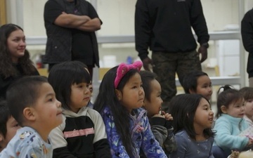 U.S. Marines with 4th Law Enforcement Battalion distribute toys to children attending June Nelson Elementary School during a Toys for Tots operation in Kotzebue, Alaska, Dec. 8, 2025.