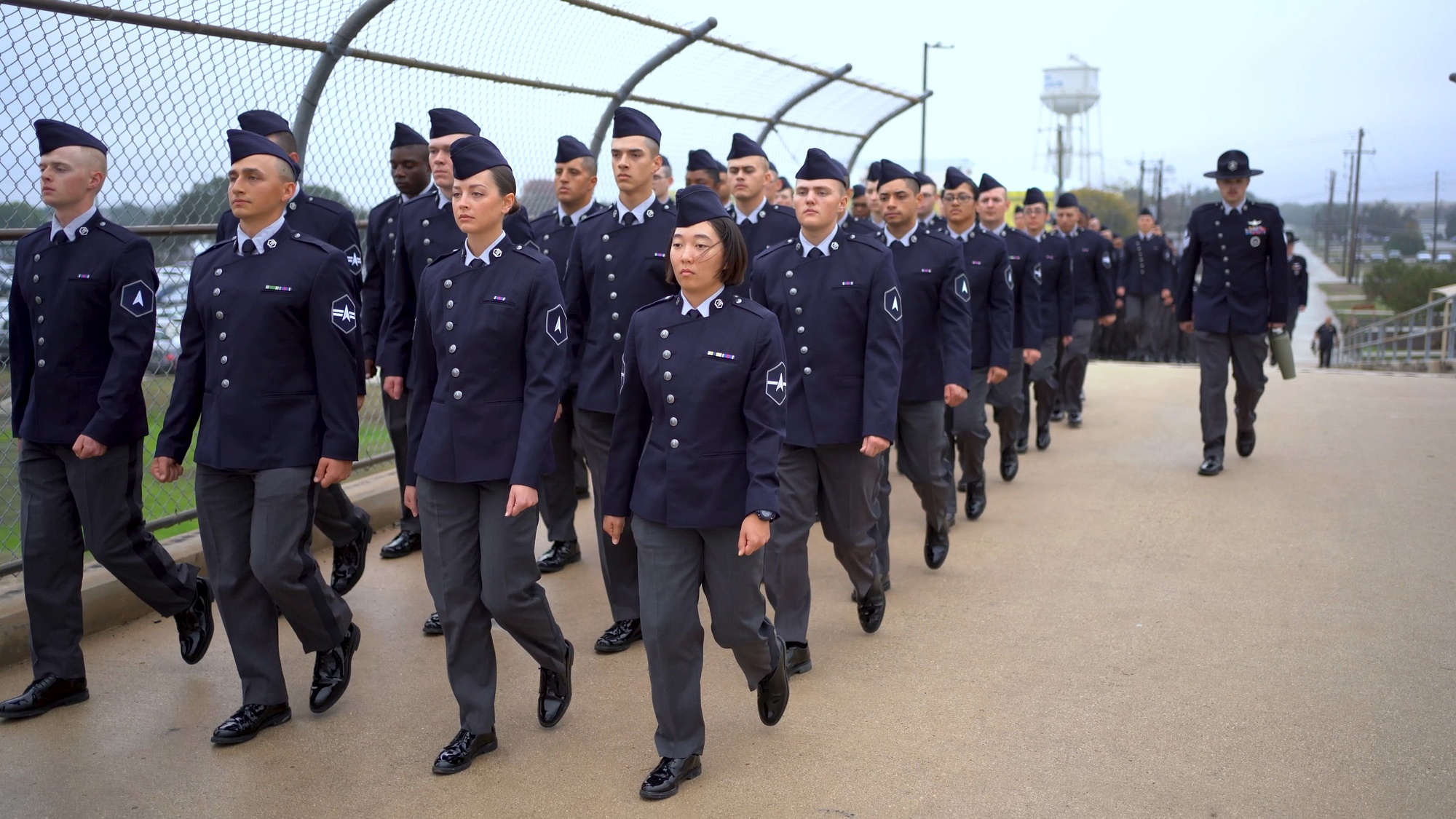 The journey of newly graduated U.S. Space Force Guardians through Basic Military Training unfolds at Joint Base San Antonio–Lackland, Texas, December 18, 2025. The event, hosted by the 737th Training Group, marks the completion of Department of the Air Force Basic Military Training. Guardians wore the new Space Force service dress uniform for the first time at a BMT graduation, representing the service’s evolving identity and shared training foundation with the U.S. Air Force. (U.S. Space Force photo by Isaac Blancas)