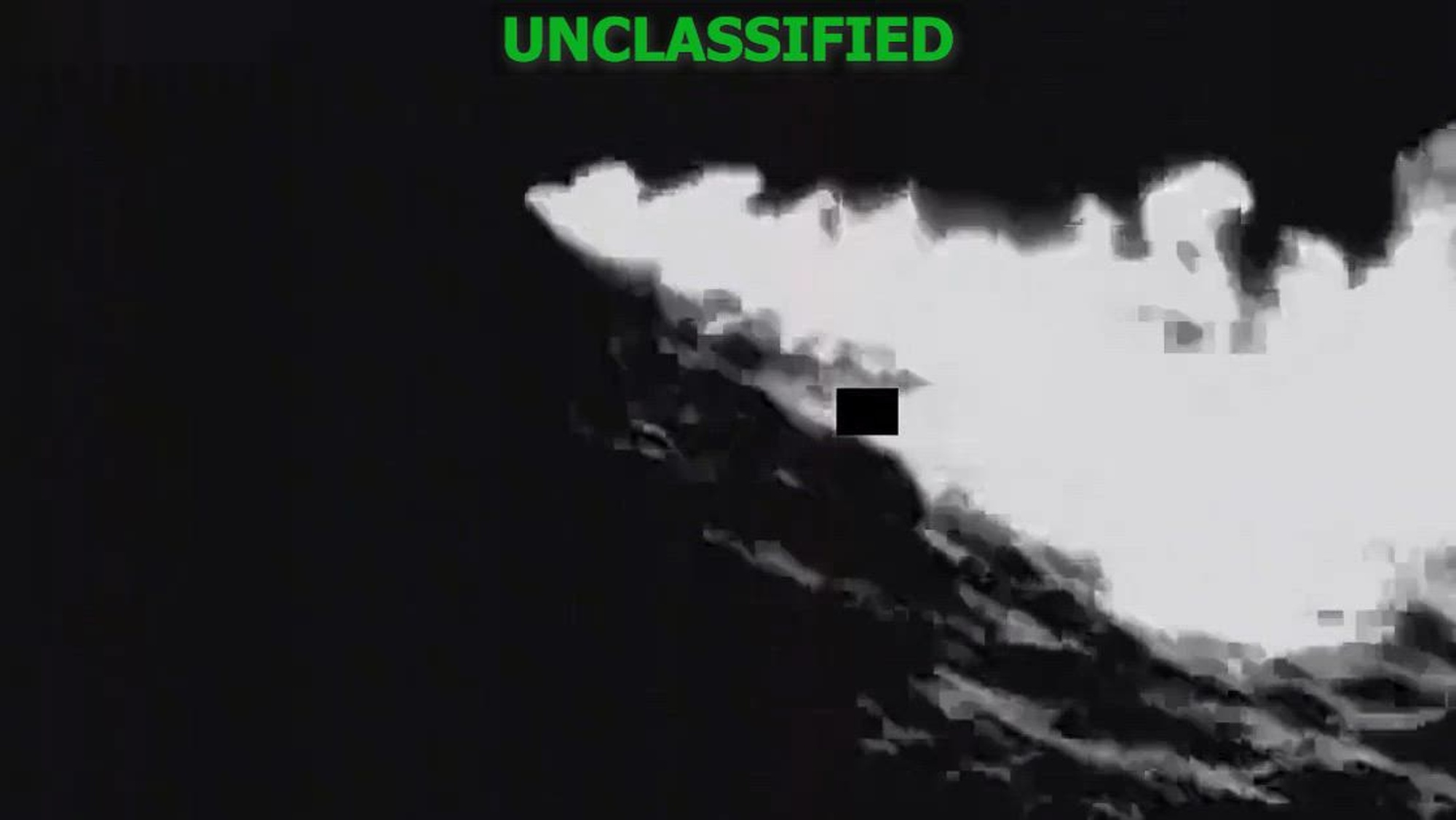 Black and white overhead footage of a lethal kinetic strike as a boat explodes.