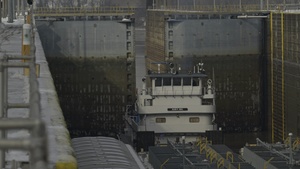 Barge locking through McAlpine Locks and Dam during freezing conditions b-roll 4k