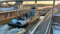 Barge locking through McAlpine Locks and Dam during freezing conditions b-roll 4k