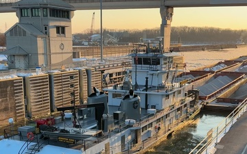 Barge locking through McAlpine Locks and Dam during freezing conditions b-roll 4k