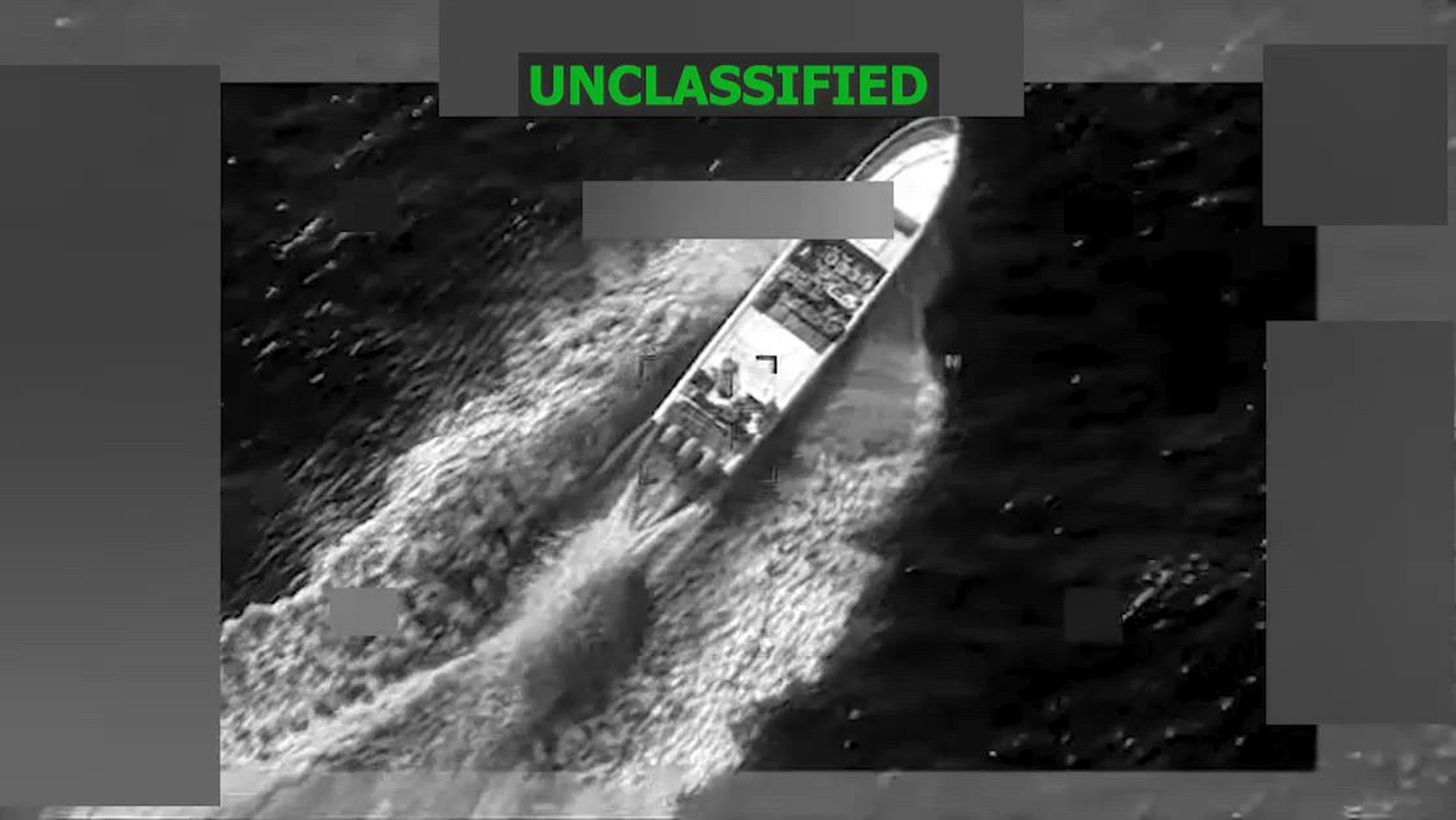 A black and white overhead video of a boat being struck in the water.