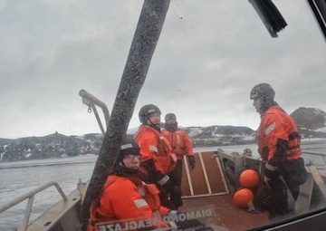 USCGC Polar Star (WAGB 10) supports the installation of a pier in McMurdo Station during Operation Deep Freeze 2026
