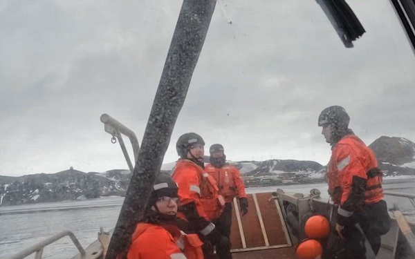 USCGC Polar Star (WAGB 10) supports the installation of a pier in McMurdo Station during Operation Deep Freeze 2026