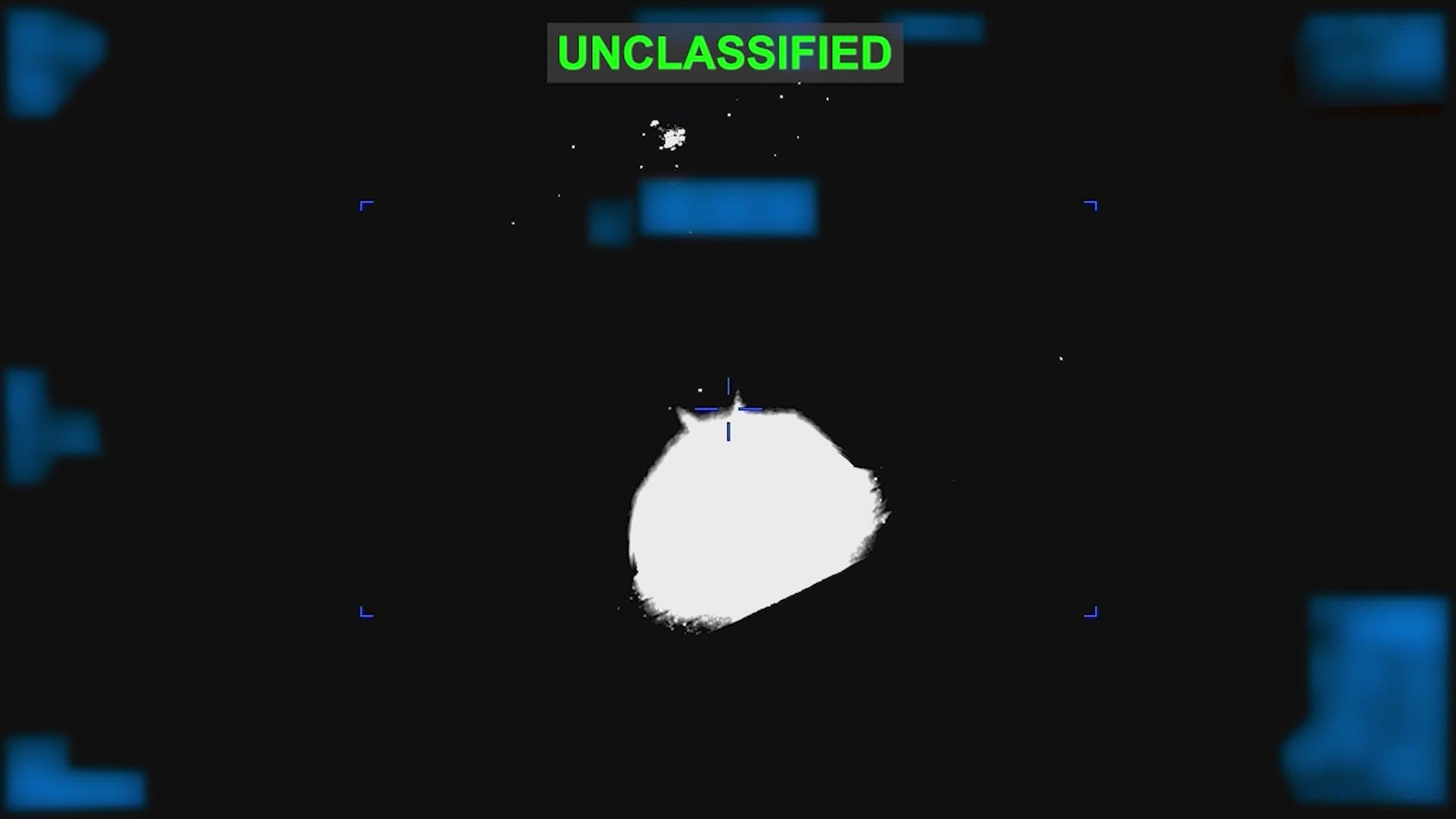A circular flash of light is at the center of a mostly black screen, with the words "UNCLASSIFIED" in green at the top.