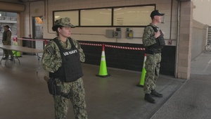 US Sailors Stand Watch pierside the USS Nimitz
