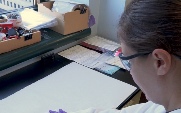 B-roll CBP chemists weigh and sort seized drugs.