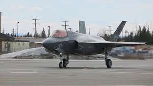 U.S. service members unload ordnance from aircraft participating in exercise Red Flag-Alaska