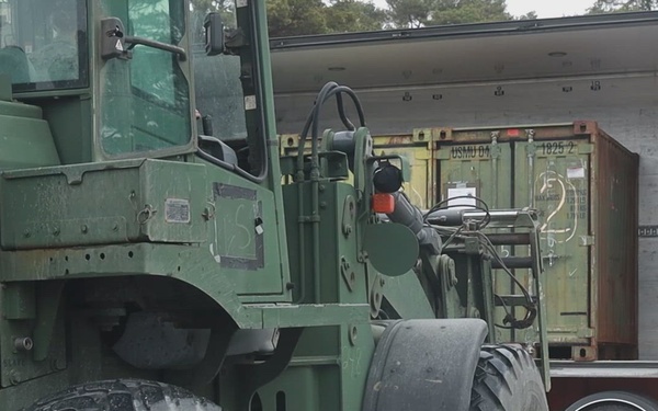 U.S. Marines unload logistical equipment in Sweden
