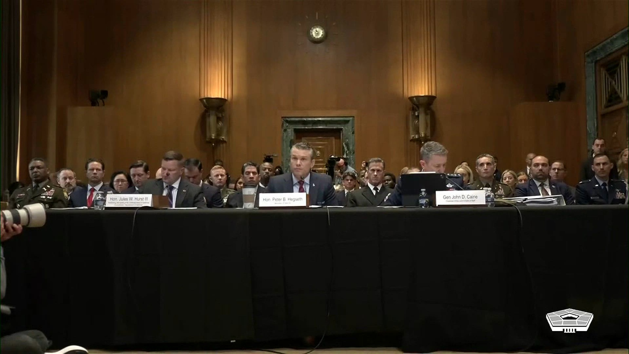 Secretary of War Pete Hegseth and Air Force Gen. Dan Caine, chairman of the Joint Chiefs of Staff, testify on the War Department’s fiscal year 2027 budget request before the Senate Appropriations Committee’s defense subcommittee during a hearing in Washington, May 12, 2026.