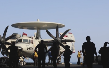 Sailors tow aircraft aboard USS George H.W. Bush