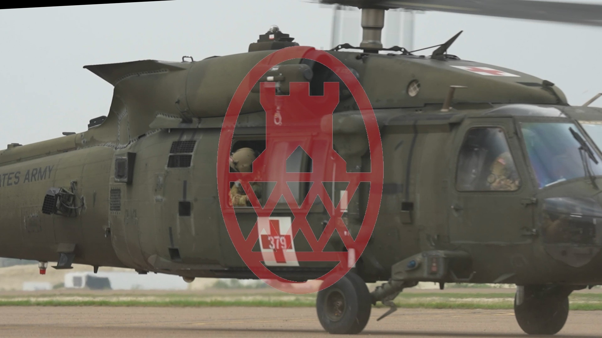 Soldiers sit in an Army helicopter. 