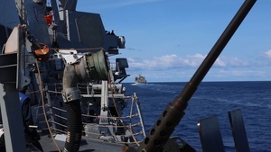 USS Mustin conducts a replenishment-at-sea with USNS Arctic