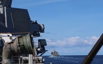 USS Mustin conducts a replenishment-at-sea with USNS Arctic