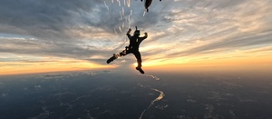 The U.S. Army Parachute Team jumps at sunset over Washington Monument for Freedom 250 events