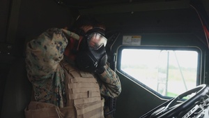 U.S. Marines conduct a simulated reaction convoy with gas masks in the Baltic Region