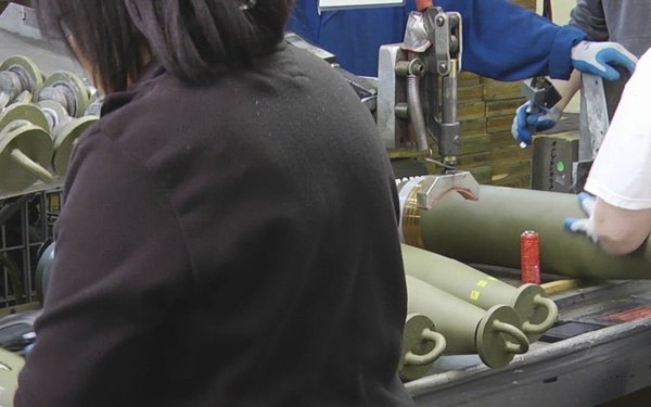 Inspection process following capping for 155mm/M795 projectile round production at Iowa Army Ammunition Plant.