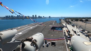 USS Carl Vinson team hoists display car onto the flight deck for NASCAR San Diego Weekend