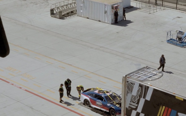 USS Carl Vinson team hoists display car onto the flight deck for NASCAR San Diego Weekend