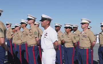 U.S. Marines and Sailors man the rails aboard the USS Arlington (LPD-24)